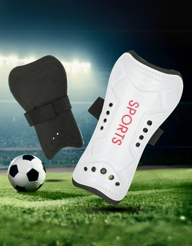 White soccer shin guards with straps for leg protection during football games.